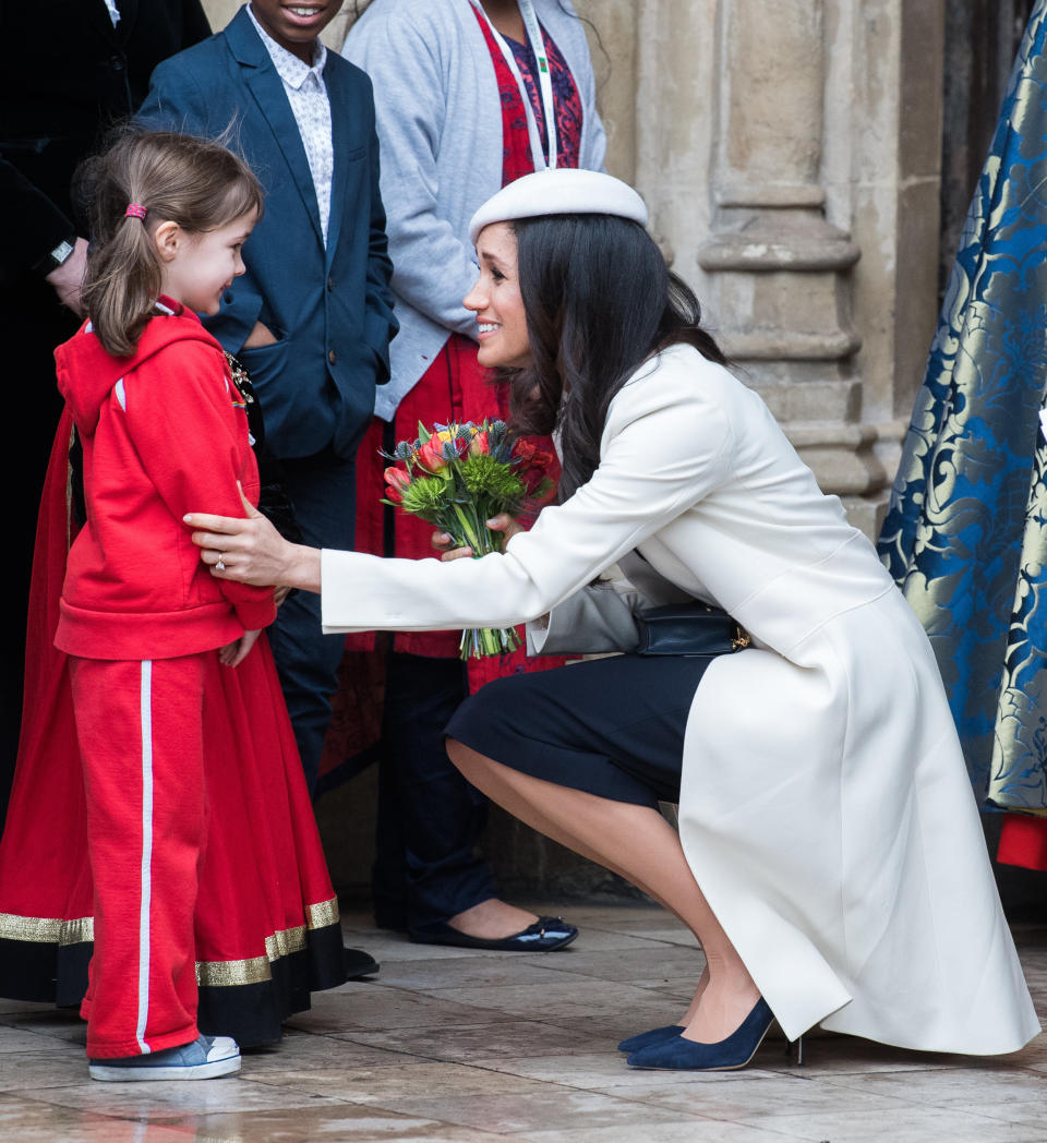 The soon-to-be duchess&nbsp;crouched down to meet a&nbsp;young fan. (Photo: Samir Hussein via Getty Images)