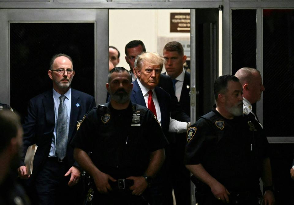 Donald Trump is led into court for his arraignment on charges of paying hush money to adult actress Stormy Daniels (AFP via Getty Images)