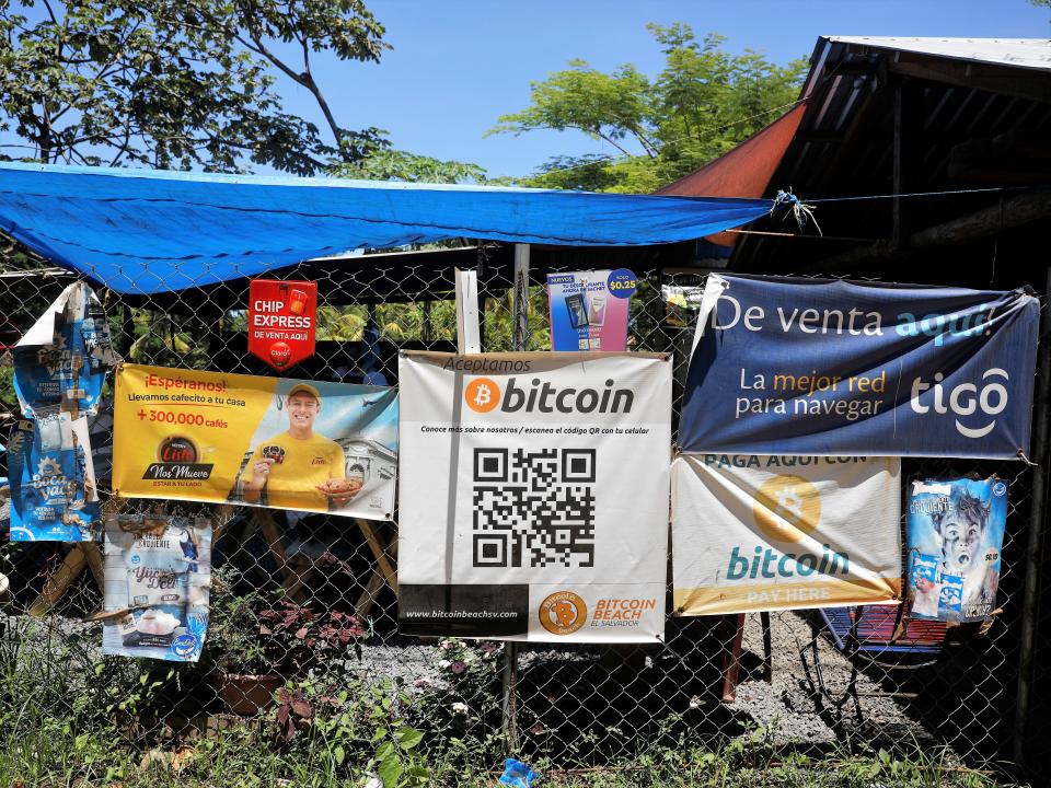 Bitcoin banners are seen outside of a small restaurant at El Zonte Beach in Chiltiupan, El Salvador 8 June, 2021 (Reuters)