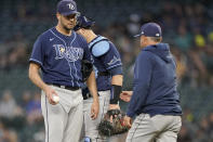 Tampa Bay Rays starting pitcher Rich Hill, left, is pulled from the baseball game against the Seattle Mariners by manager Kevin Cash, right, during the sixth inning Thursday, June 17, 2021, in Seattle. (AP Photo/Ted S. Warren)