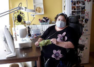 In this photo taken on Thursday, March 19, 2020, Sien Lagae, shows her creation of a mouth mask, meant to help protect from the spread of COVID-19, that she produced on her sewing machine at home in Torhout, Belgium. Lagae runs a social media group of volunteers who are making mouth masks for family and friends as well as hospital and caregivers in Belgium due to a shortage in supply of industrially made masks. For most people, the new coronavirus causes only mild or moderate symptoms, such as fever and cough. For some, especially older adults and people with existing health problems, it can cause more severe illness, including pneumonia. (Sien Lagae via AP)