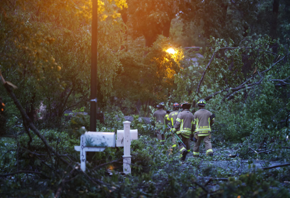 Firefighters work the scene in a Virginia Beach neighborhood off Great Neck road after a late afternoon storm moved through damaging homes on Sunday, April 30, 2023. (Billy Schuerman/The Virginian-Pilot via AP)