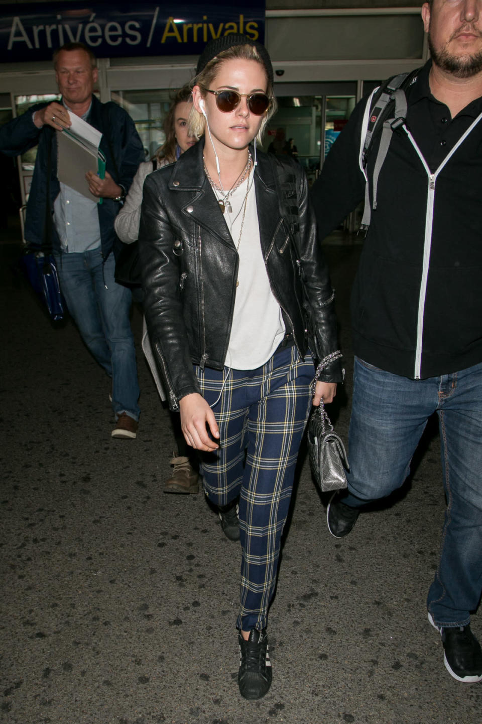 Kristen Stewart in plaid pants and a leather jacket 