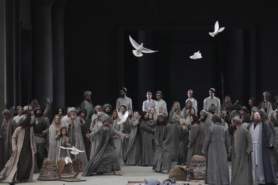 Rochus Rueckel as Jesus, left, performs with the cast during the rehearsal of the 42nd Passion Play in Oberammergau, Germany, Wednesday, May 4, 2022. After a two-year delay due to the coronavirus, Germany's famous Oberammergau Passion Play is opening soon. The play dates back to 1634, when Catholic residents of a small Bavarian village vowed to perform a play of the last days of Jesus Christ every 10 years, if only God would spare them of any further Black Death victims. The town did suffer some COVID-19 deaths, but the show goes on. Almost half of the village's residents— more than 1,800 people including 400 children — will participate. (AP Photo/Matthias Schrader)