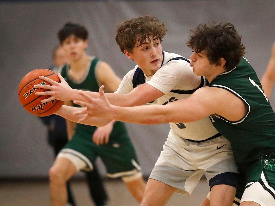 Nick Marcel works to keep the ball from Duxbury guard Alexander Barlow.Plymouth North hosted Duxbury in boys basketball action on Friday February 3, 2023 