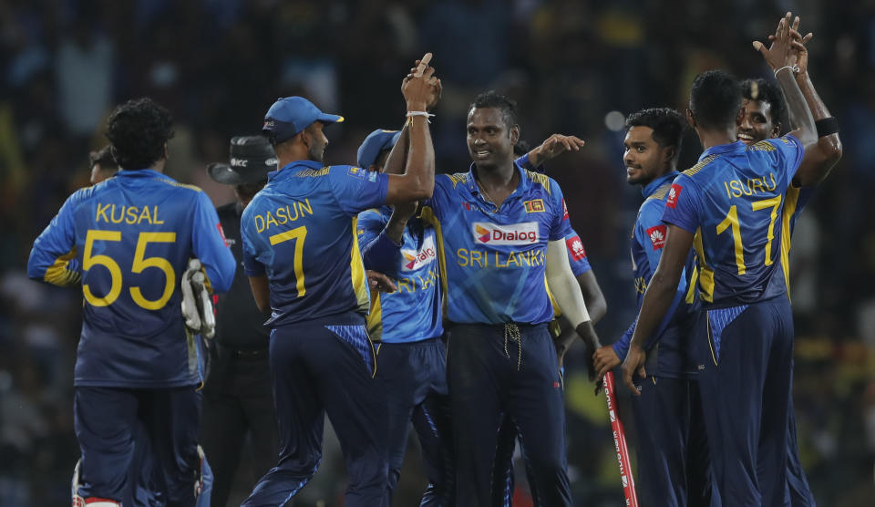 Sri Lankan team members celebrate their victory over West Indies' by six runs in the third one day international cricket match between Sri Lanka and West Indies in Pallekele, Sri Lanka, Sunday, March 1, 2020. (AP Photo/Eranga Jayawardena)