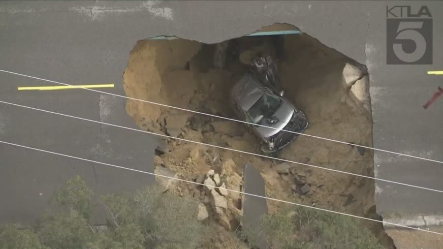 A vehicle that became stuck in a Chatsworth sinkhole Monday night. (KTLA)