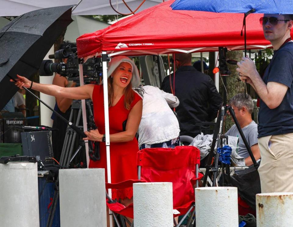 Voice of America journalist Celia Mendoza, left, tries to close her umbrella as the rain comes down and news media take cover from the afternoon deluge. On Monday, June 12, 2023, the media set up on the lawn of the Wilkie D. Ferguson Jr. U.S. Courthouse in preparation for Donald J. Trump’s federal court appearance Tuesday at 3 p.m. Trump is facing 37 counts in a federal indictment related to his handling of classified documents after he left office. He is the first former president to face federal criminal charges.