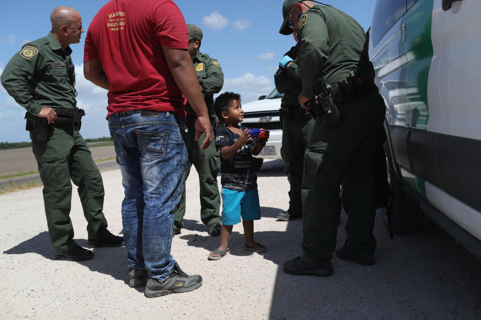 A boy and father from Honduras are taken into custody by U.S. Border Patrol agents near the U.S.-Mexico Border on June 12, 2018, near Mission, Texas. The asylum-seekers were then sent to a U.S. Customs and Border Protection (CBP) processing center for possible separation. (Photo: John Moore via Getty Images)