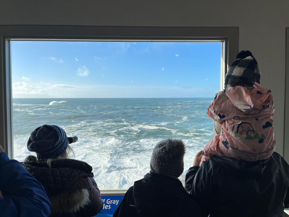 A family looks for gray whales during whale watch week at the Whale Watching Center in Depoe Bay in December 2022.