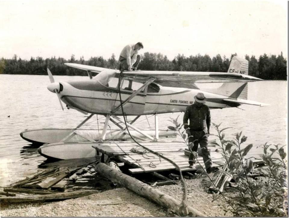 Undated photo of Merlyn Carter of Hay River, N.W.T., on top of his father George's plane. 