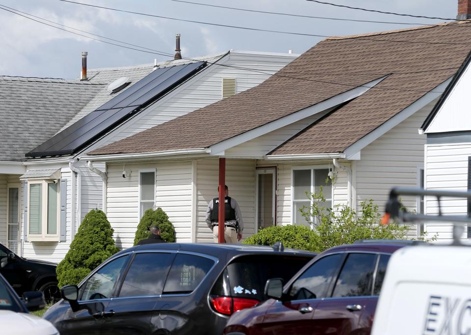 A detective stands on the porch of 157 Highland Boulevard in Keansburg Tuesday morning May 2, 2023, as an investigation of an earlier incident there continues.