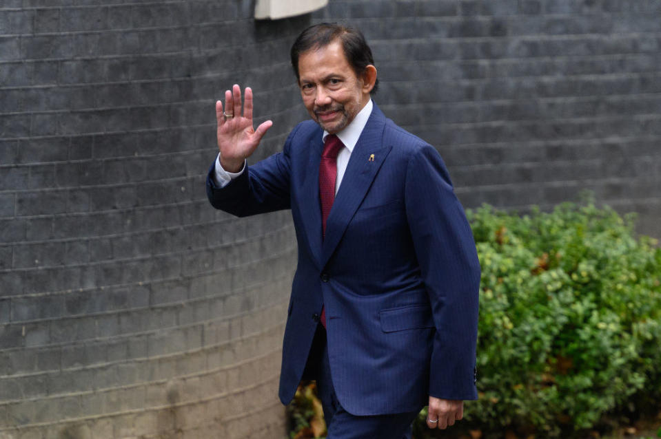 Sultan Hassanal Bolkiah walking and waving