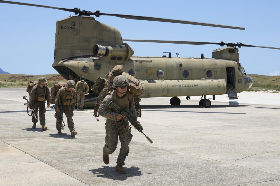 U.S. troopers alight from a U.S. Army CH-47 carrying American and Philippine troops as it lands at the Philippines' northernmost town of Itbayat, Batanes province during a joint military exercise on Monday, May 6, 2024. American and Filipino marines held annual combat-readiness exercises called Balikatan, Tagalog for shoulder-to-shoulder, in a show of allied battle readiness in the Philippines' northernmost island town of Itbayat along the strategic Bashi Channel off southern Taiwan. (AP Photo/Aaron Favila)