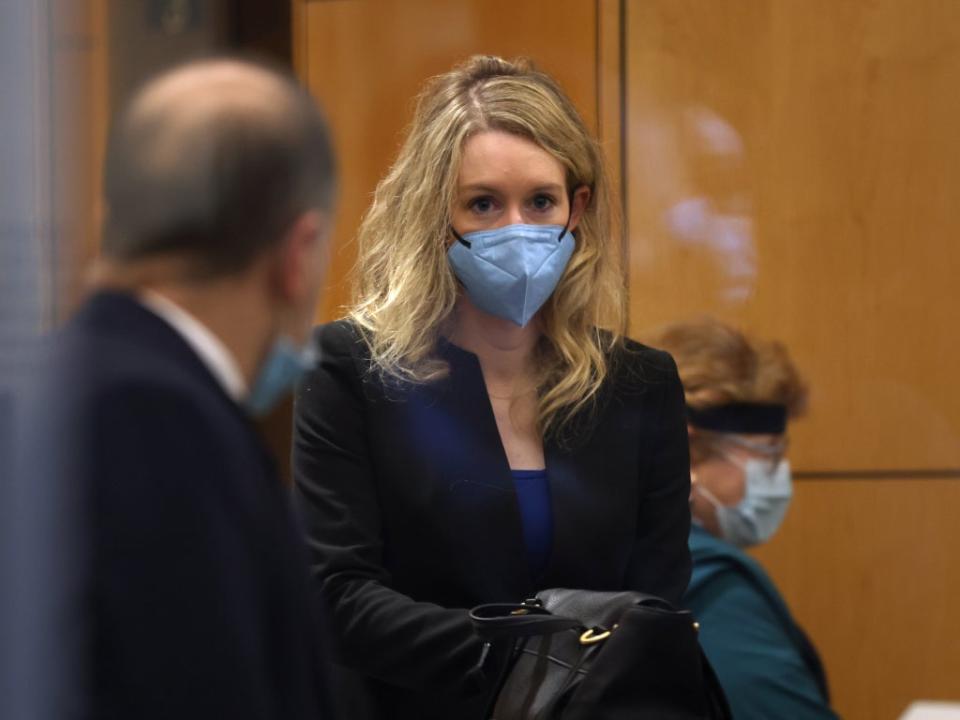 Elizabeth Holmes wears a black blazer and blue top during her trial in December - but no sign of a turtleneck (Getty)