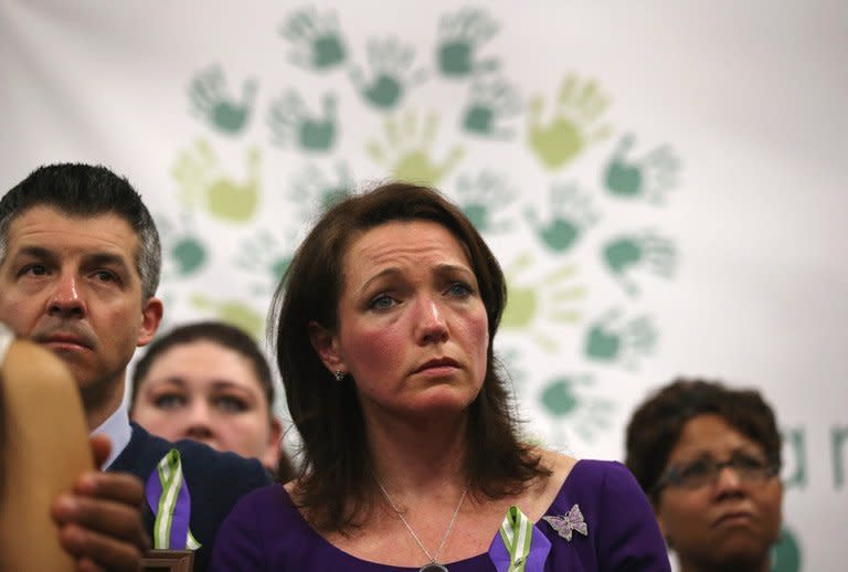 Nicole and Ian Hockley, parents of Sandy Hook massacre victim Dylan Hockley, age 6, listen during a press conference with fellow parents of victims on the one month anniversary of the Newtown elementary school massacre on January 14, 2013