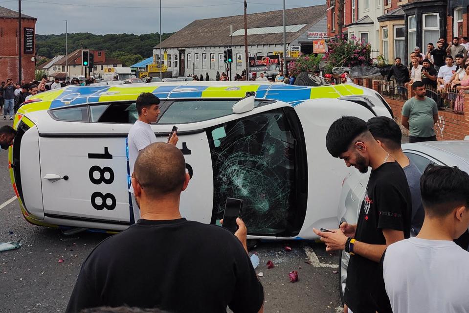 A police vehicles on its side during the unrest in Harehills estate in Leeds (â€œ@robin_singhâ€ via REUTERS)