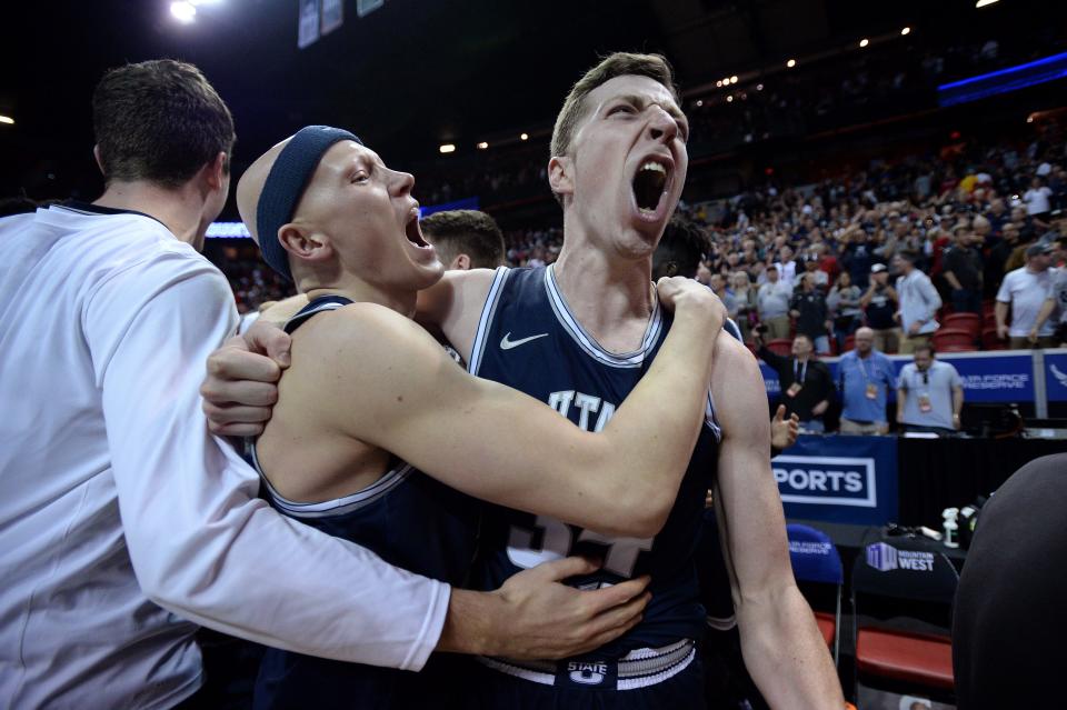 Mar 7, 2020; Las Vegas, Nevada, USA; Utah State Aggies forward Justin Bean (right) and guard Brock Miller (middle) celebrate after defeating the San Diego State Aztecs in the Mountain West Conference tournament final at Thomas and Mack Center. Mandatory Credit: Orlando Ramirez-USA TODAY Sports ORG XMIT: USATSI-425887 ORIG FILE ID:  20200307_gma_rb5_105.jpg