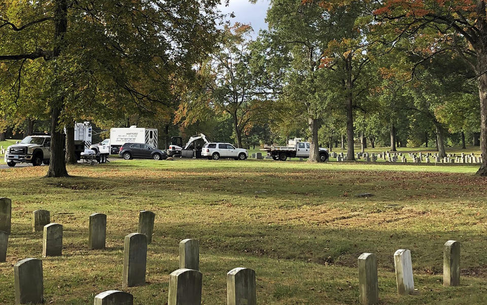 Authorities exhume the remains of two unidentified victims of the 1944 Hartford circus fire, Monday, Oct. 7, 2019, at the Northwood Cemetery in Windsor, Conn. Officials will try to determine if one of them is Grace Fifield, of Newport, Vt. Grace Fifield was never seen again after attending the circus. The fire in the big top of the Ringling Brothers and Barnum & Bailey Circus killed 168 people and injured 682 others. (AP Photo/Dave Collins)