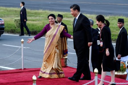 Nepal's President Bidhya Devi Bhandari welcomes China's President Xi Jinping upon his arrival at Tribhuvan International Airport in Kathmandu