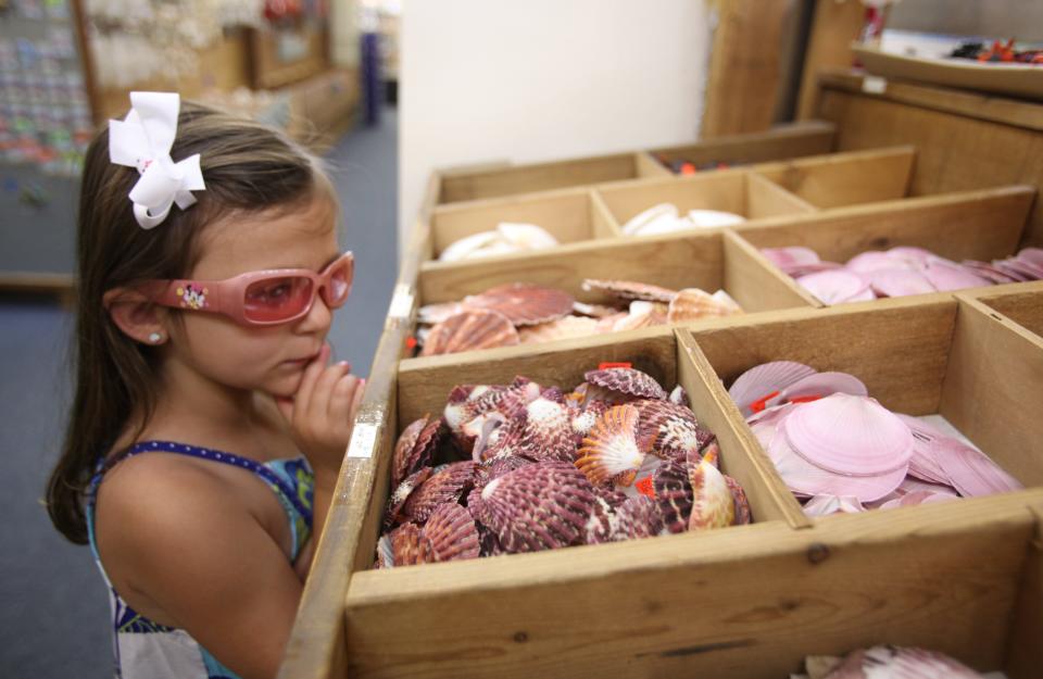 A young consumer shops for souvenirs at Souvenir City in Gulf Shores in this March 5, 2011, photo. [Staff file photo]