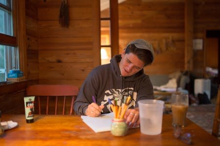 Quail Hill farmer Layton Guenther (L) prepares before the day's farm work in Amagansett