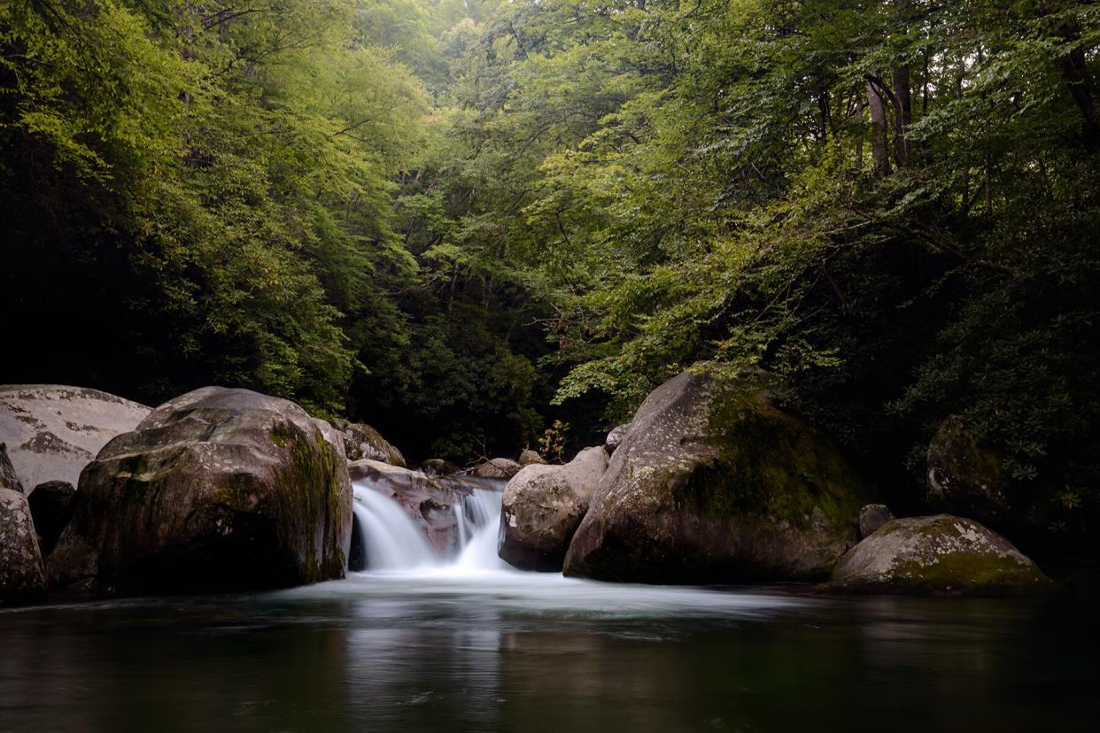 The small waterfall into the deep pool known as Midnight Hole in Great Smoky Mountains National Park is a popular swimming hole along the Mouse Creek Falls trail.