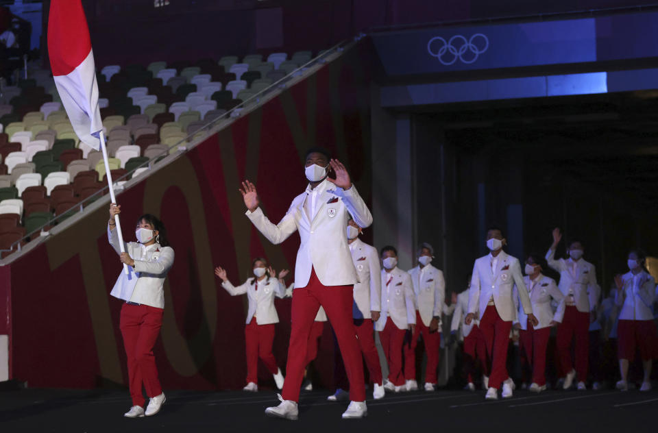 FILE - In this July 23, 2021, file photo, Yui Susaki and Rui Hachimura, front right, of Japan, carry their country's flag during the opening ceremony in the Olympic Stadium at the 2020 Summer Olympics in Tokyo, Japan. The racial diversity Japan showcased at the Olympic opening ceremony also highlights its lack in Japanese society. (Hannah McKay/Pool Photo via AP, File)