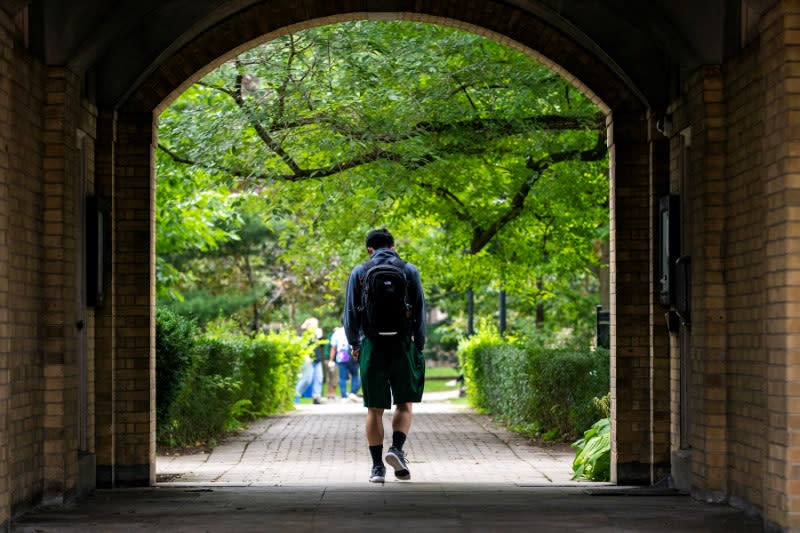Students walk on the grounds of the University of Toronto in Toronto