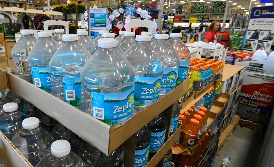 Pallets of water jugs and Gatorade greet customers inside the front doors of Lowe's in West Melbourne ahead of Tropical Storm Ian's possible impacts.