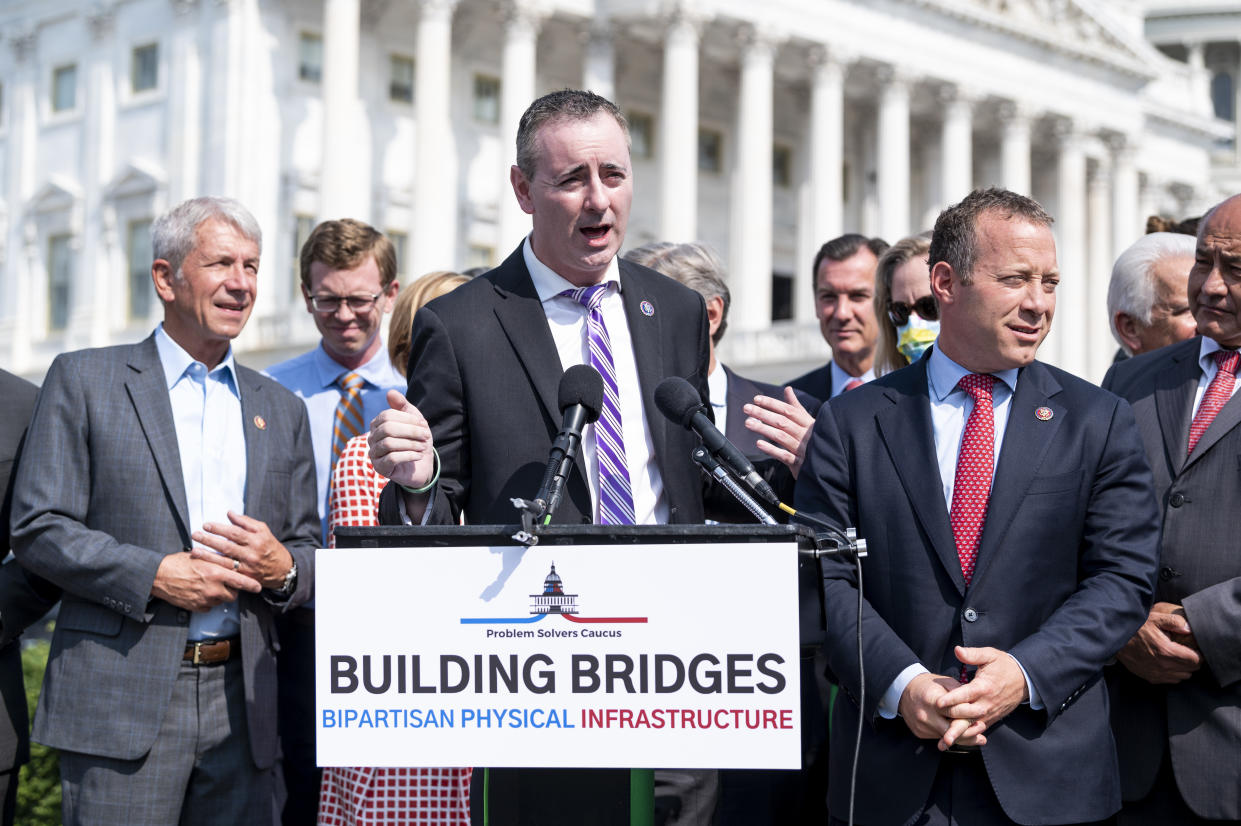 UNITED STATES - JULY 30: Rep. Brian Fitzpatrick, R-Pa., speaks as Rep. Josh Gottheimer, D-N.J., right, listens during the Problem Solvers Caucus news conference on the infrastructure deal outside of the Capitol on Friday, July 30, 2021. (Photo by Bill Clark/CQ-Roll Call, Inc via Getty Images)