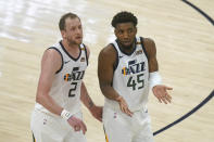 Utah Jazz's Joe Ingles (2) and Donovan Mitchell (45) talk as they walk upcourt in the first half during an NBA basketball game against the Sacramento Kings, Saturday, April 10, 2021, in Salt Lake City. (AP Photo/Rick Bowmer)