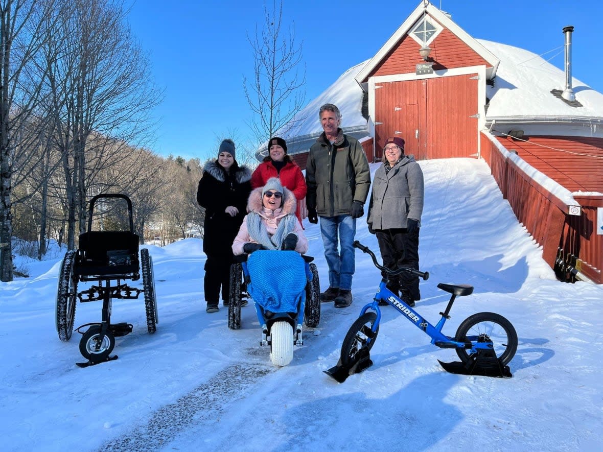 Nathalie Thibeault, far left, and her daughter Andrée-Ann Madore, seated in the wheelchair, toured the Gorge Park in Coaticook Que. with park staff. Thibeault asked the park to get wheelchairs that would allow everyone to enjoy the outdoors.  (Submitted by Parc de la Gorge de Coaticook - image credit)