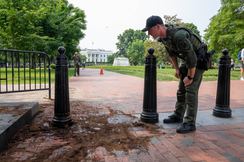 A U.S. Park Police officer inspects a security barrier for damage in Lafayette Square park near the White House (Copyright 2023 The Associated Press. All rights reserved.)