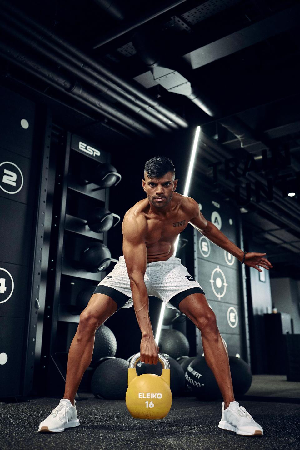 Dr Amar Shere lifting a kettlebell weight in the gym
