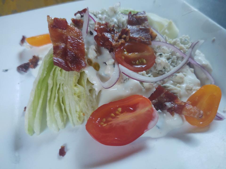 At Chill & Grill in Vero Beach, the iceberg wedge salad has bacon, tomatoes, onion slices, blue cheese crumbles and blue cheese dressing.