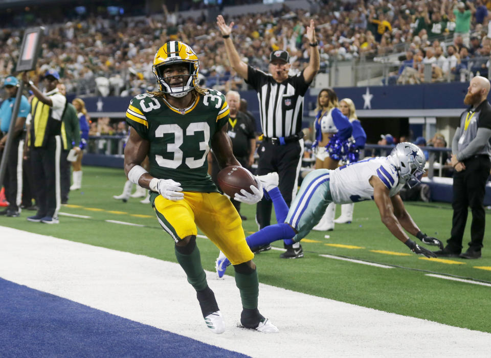 Green Bay Packers' Aaron Jones (33) reaches the end zone for a touchdown in front of Dallas Cowboys' Byron Jones, rear, during the second half of an NFL football game in Arlington, Texas, Sunday, Oct. 6, 2019. (AP Photo/Michael Ainsworth)