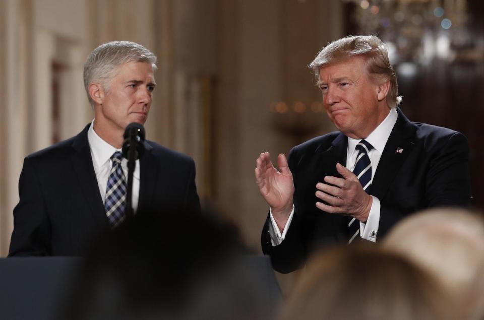 In this Jan. 31, 2017, photo, President Donald Trump applauds as he stands with Judge Neil Gorsuch in East Room of the White House in Washington, after announcing Gorsuch as his nominee for the Supreme Court. Two weeks into his presidency, Donald Trump has thrown Washington into a state of anxious uncertainty. Policy pronouncements sprout up from the White House in rapid succession. Some have far-reaching implications, most notably Trump’s temporary refugee and immigration ban, but others disappear without explanation, including planned executive actions on cybersecurity and the president’s demand for an investigation into unsubstantiated voter fraud. The day’s agenda can quickly be overtaken by presidential tweets, which often start flashing on smartphones just as the nation’s capital is waking up. (AP Photo/Carolyn Kaster)