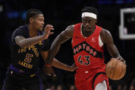 Los Angeles Lakers forward Cam Reddish (5) defends against Toronto Raptors forward Pascal Siakam (43) during the first half of an NBA basketball game in Los Angeles, Tuesday, Jan. 9, 2024. (AP Photo/Ashley Landis)