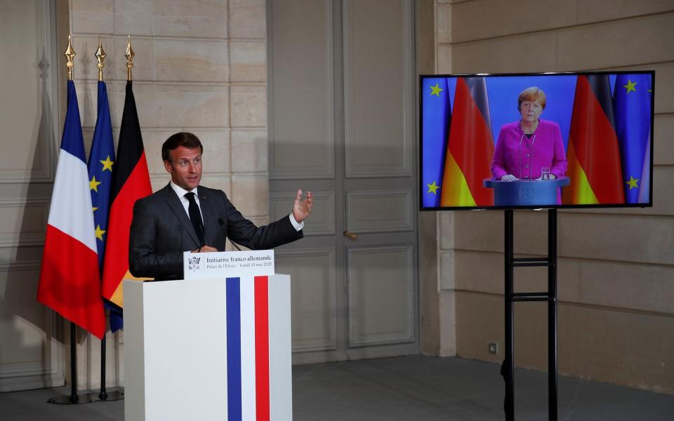 French President Emmanuel Macron speaks at a joint video news conference with German Chancellor Angela Merkel to discuss Europe's economic recovery plans - POOL/REUTERS