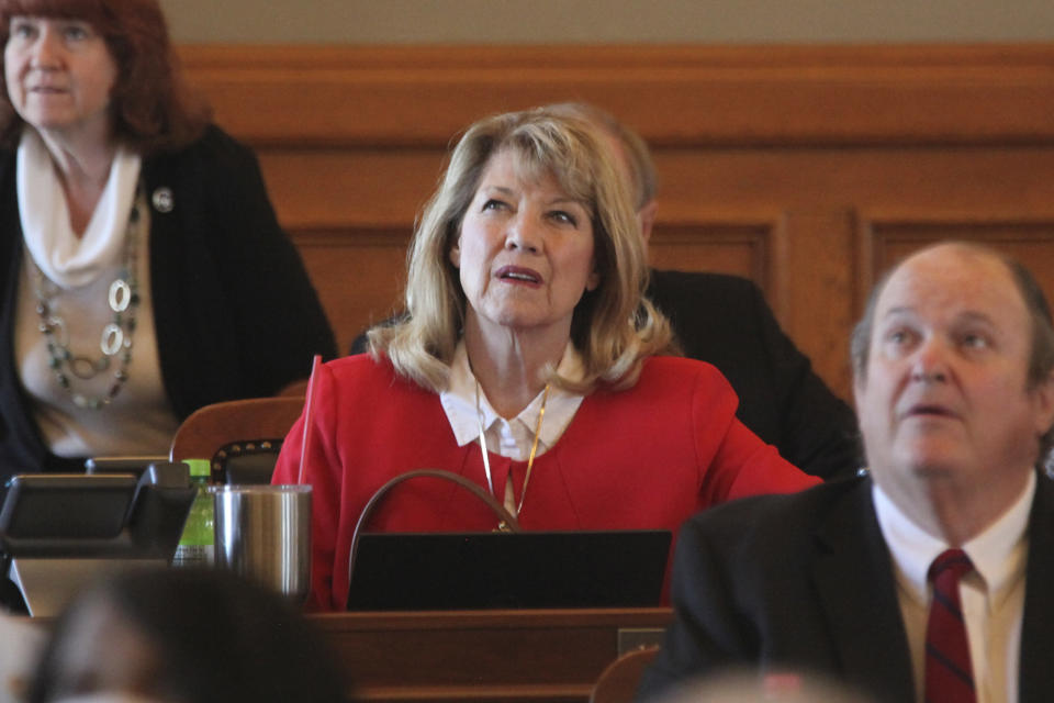 FILE - Kansas state Rep. Cheryl Helmer, center, R-Mulvane, watches one of the House's electronic tally board during a vote, Tuesday, April 26, 2022, at the Statehouse in Topeka, Kan. Helmer made headlines for saying in an email that she didn't want to share a bathroom with a transgender colleague. (AP Photo/John Hanna, File)