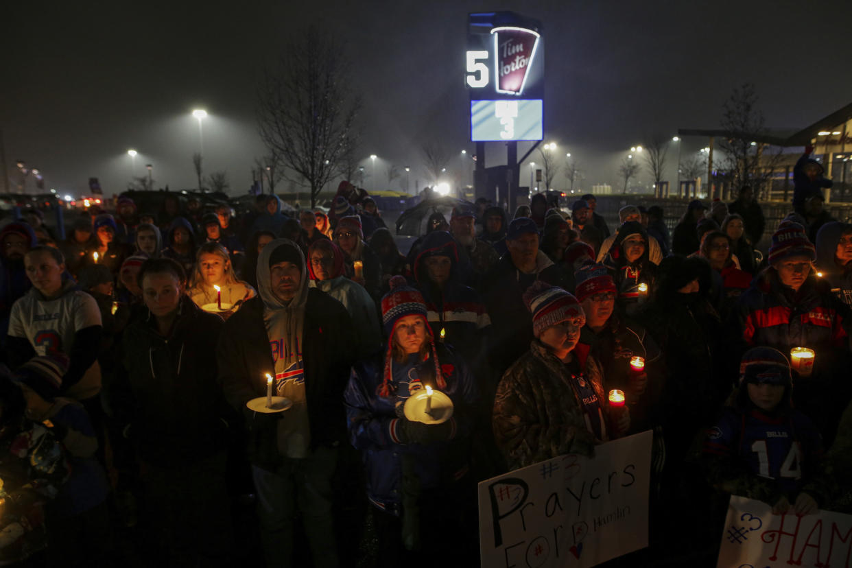 Buffalo Bills fans and community members gather for a candlelight vigil for Buffalo Bills safety Damar Hamlin on Tuesday, Jan. 3, 2023, in Orchard Park, N.Y. (AP Photo/Joshua Bessex)