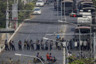 Police stand in formation blocking a main road in Mandalay, Myanmar, Saturday, Feb. 27, 2021. Myanmar security forces cracked down on anti-coup protesters in the country's second-largest city Mandalay on Friday, injuring at least three people, two of whom were shot in the chest by rubber bullets and another who suffered a wound on his leg. (AP Photo)