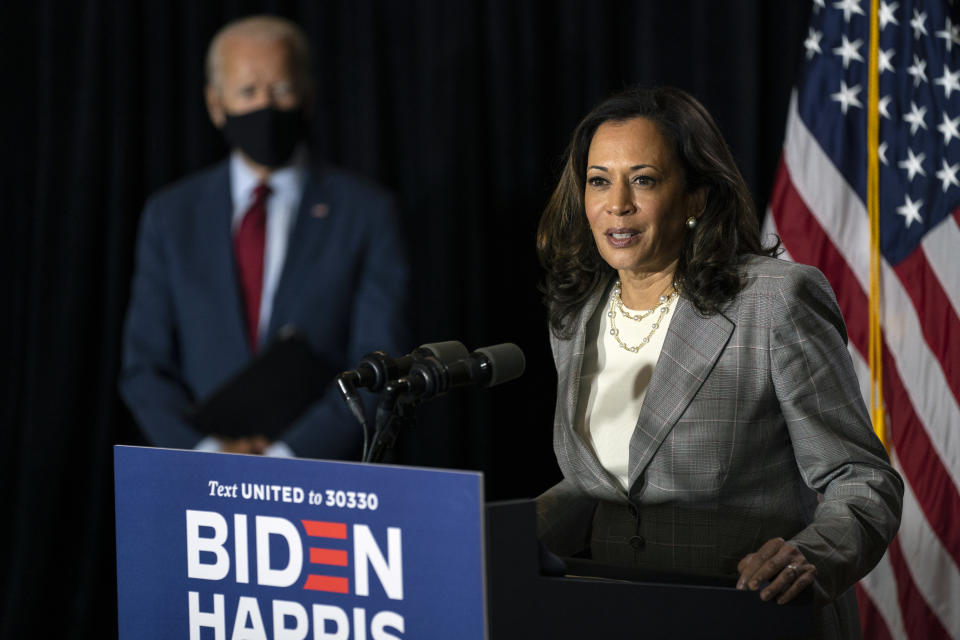 FILE - In this Aug. 13, 2020, file photo Democratic presidential candidate former Vice President Joe Biden stands left as his running mate Sen. Kamala Harris, D-Calif., speaks at the Hotel DuPont in Wilmington, Del. Democrats insist the GOP's grip on this Deep South state is weakening. It’s been nearly 15 years since a Democrat won a statewide office in South Carolina and 44 years since a Democratic presidential candidate claimed the state. (AP Photo/Carolyn Kaster, File)