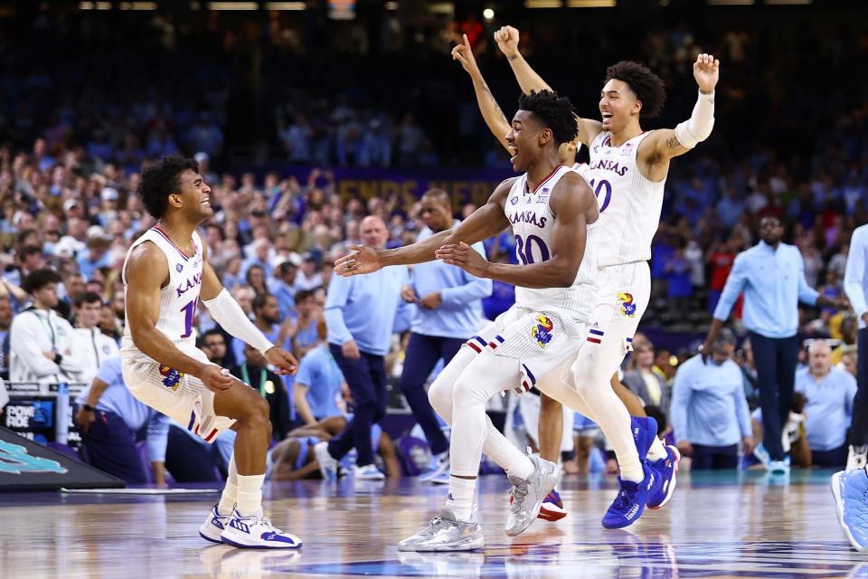 NEW ORLEANS, LOUISIANA - APRIL 04: Ochai Agbaji #30 and Remy Martin #11 of the Kansas Jayhawks celebrate after defeating the North Carolina Tar Heels to win the 2022 NCAA Men's Basketball Tournament National Championship game at Caesars Superdome on April 04, 2022 in New Orleans, Louisiana. (Photo by Jamie Schwaberow/NCAA Photos via Getty Images)