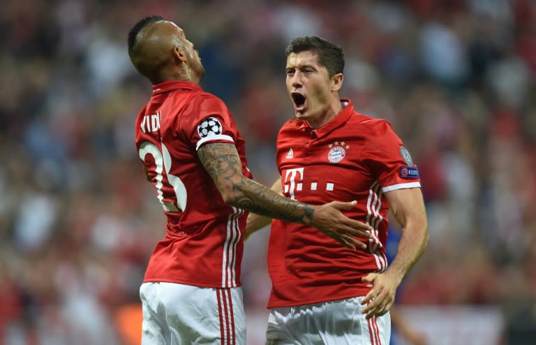 Bayern Munich's Robert Lewandowski (R) and Arturo Vidal celebrate after scoring a goal during their UEFA Champions League match against Rostov, in Munich, on September 13, 2016