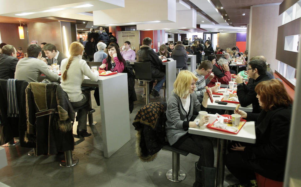 FILE - People are seen in a McDonald's restaurant at Moscow's Pushkin Square, on Feb. 1, 2010. Two months after the Berlin Wall fell, another powerful symbol opened its doors in the middle of Moscow: a gleaming new McDonald’s. It was the first American fast-food restaurant to enter the Soviet Union. But now, McDonald's is temporarily closing its 850 restaurants in Russia in response to the Ukraine invasion. (AP Photo/Ivan Sekretarev, file)