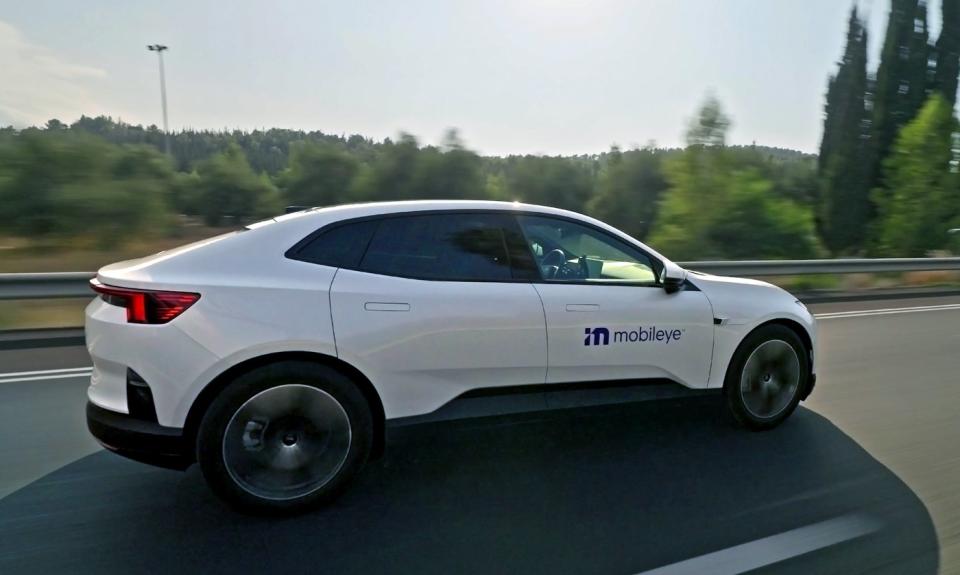 A white Polestar 4, an electric crossover SUV, with a Mobileye logo on its door. 