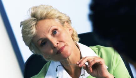 Businesswoman sitting in armchair, blurred foreground