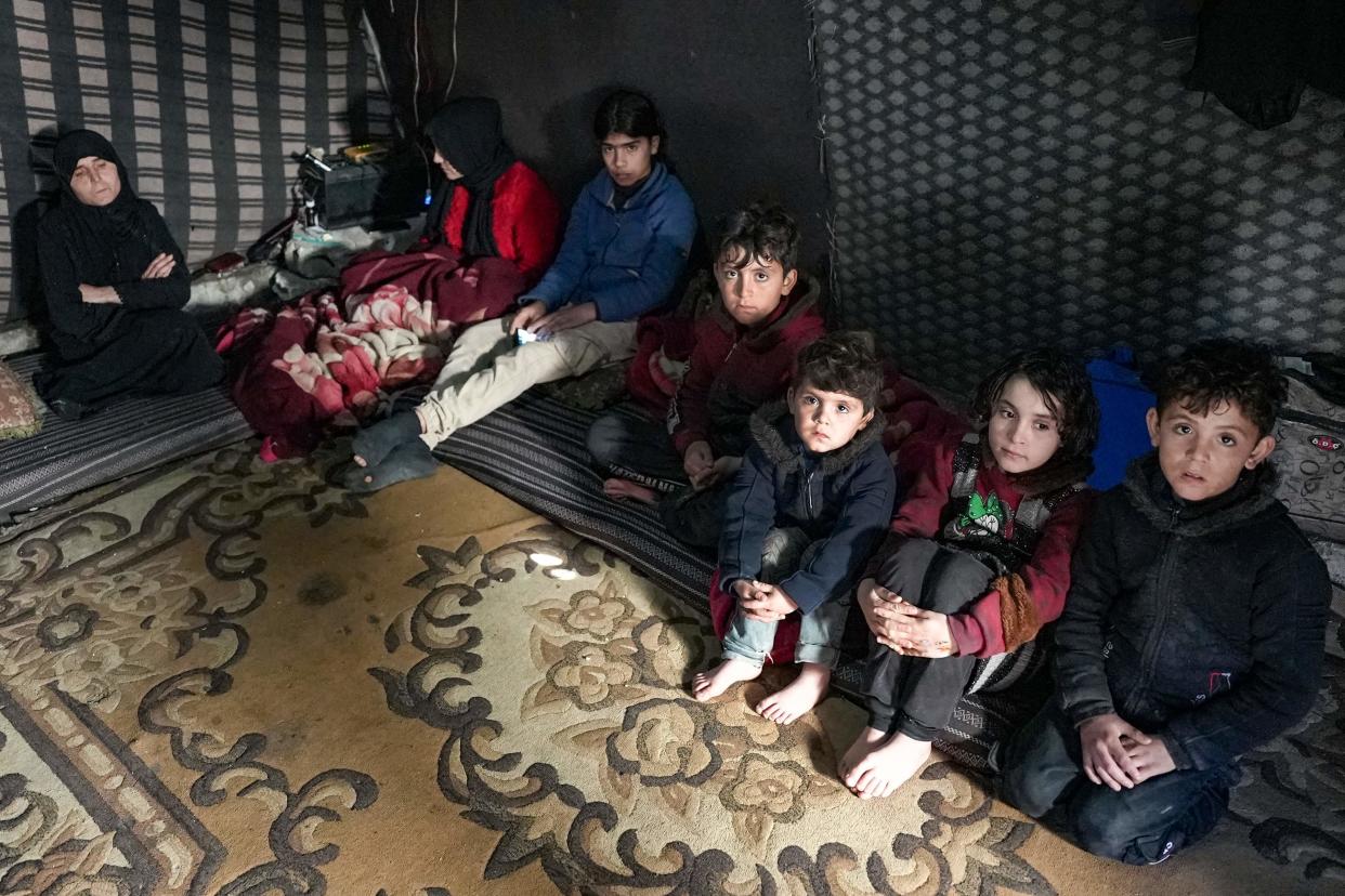 Members of a Syrian family made homeless by the earthquake rest in a make-shift shelter in the camp of Deir Ballut (Rami al SAYED/AFP via Getty Images)